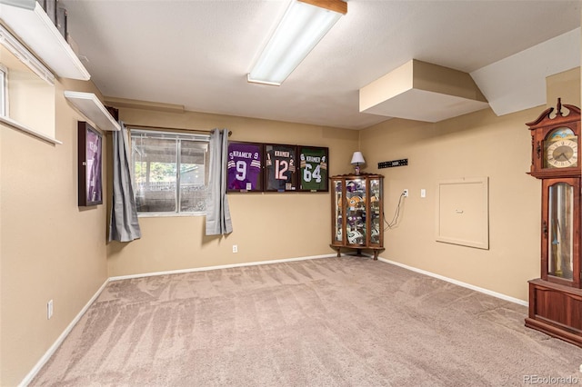 carpeted empty room featuring lofted ceiling