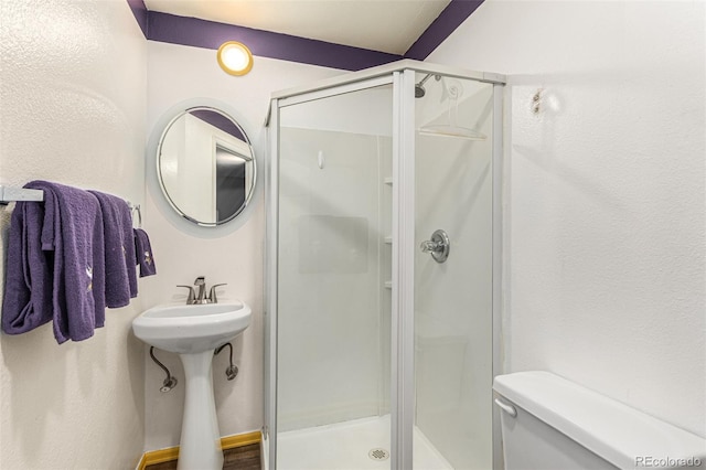 bathroom with toilet and walk in shower