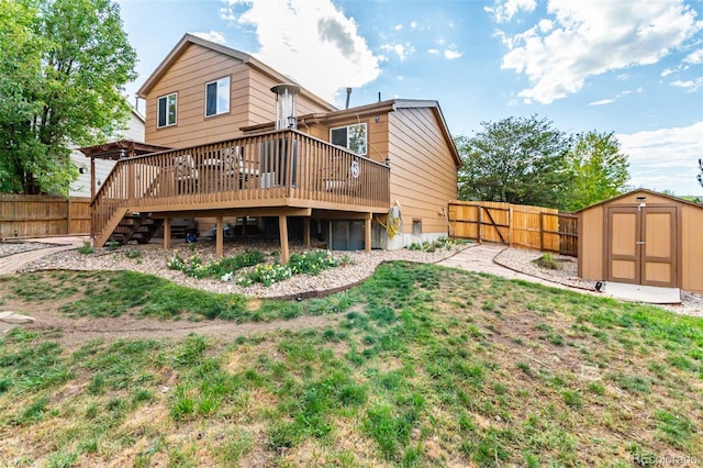 rear view of house featuring a storage unit, a lawn, and a deck