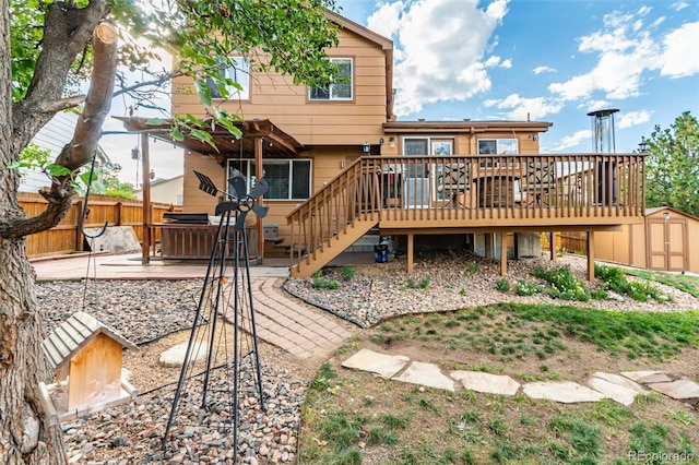 back of property with a wooden deck, a shed, and a patio area