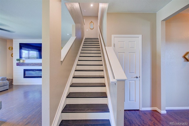 stairway with hardwood / wood-style floors