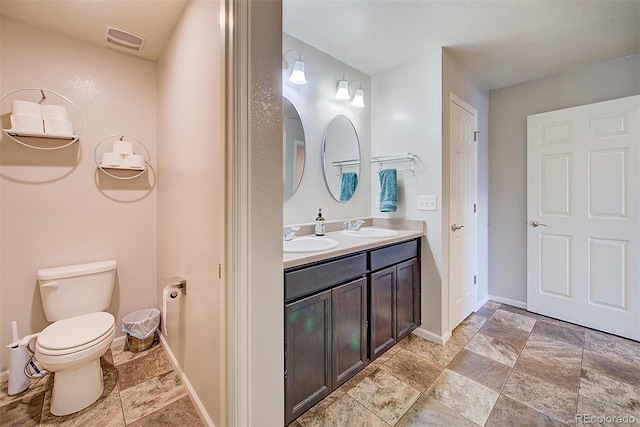 bathroom with toilet and vanity