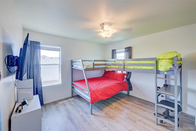 bedroom featuring hardwood / wood-style flooring, a textured ceiling, and ceiling fan