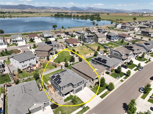 aerial view featuring a water and mountain view