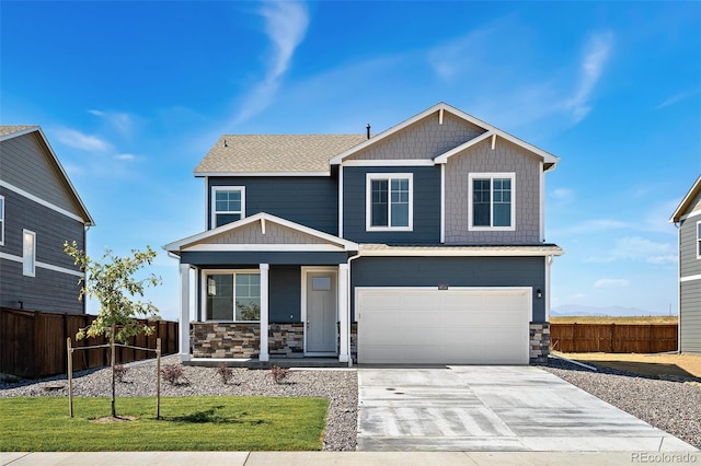 craftsman house with a front lawn, a garage, and covered porch