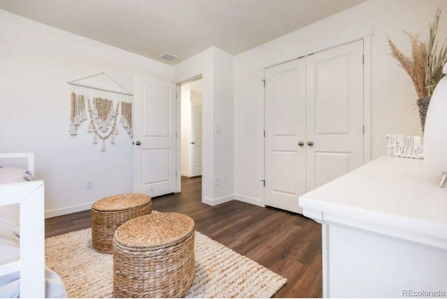 bedroom featuring dark hardwood / wood-style flooring and a closet