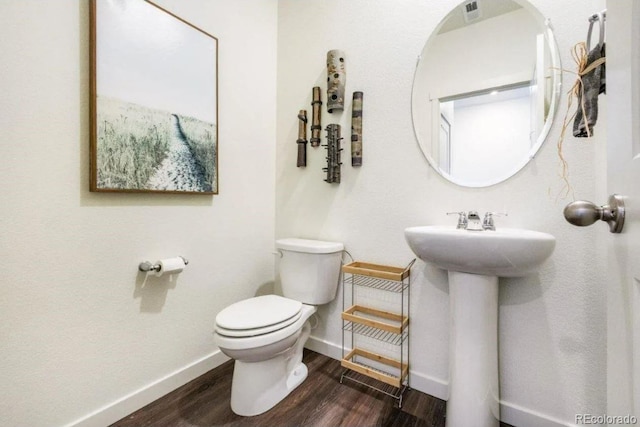 bathroom featuring toilet and hardwood / wood-style flooring