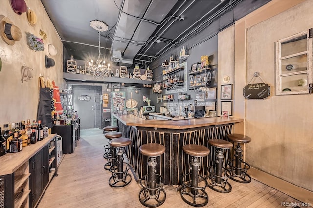 bar with light hardwood / wood-style flooring