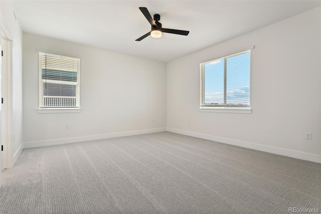 empty room featuring light colored carpet and ceiling fan