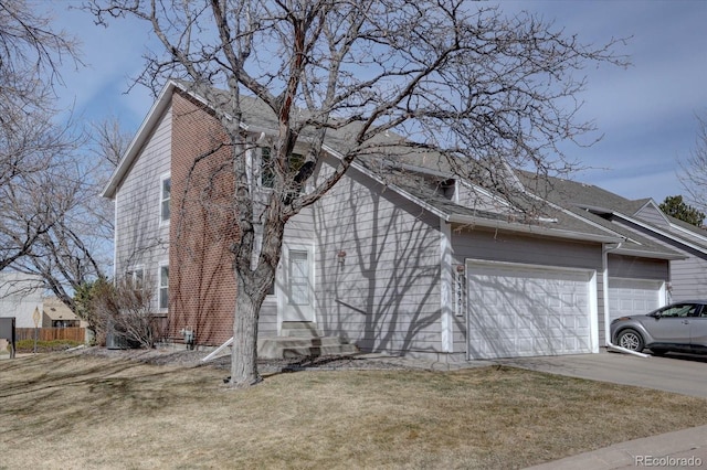 view of home's exterior featuring a lawn, entry steps, fence, concrete driveway, and a garage