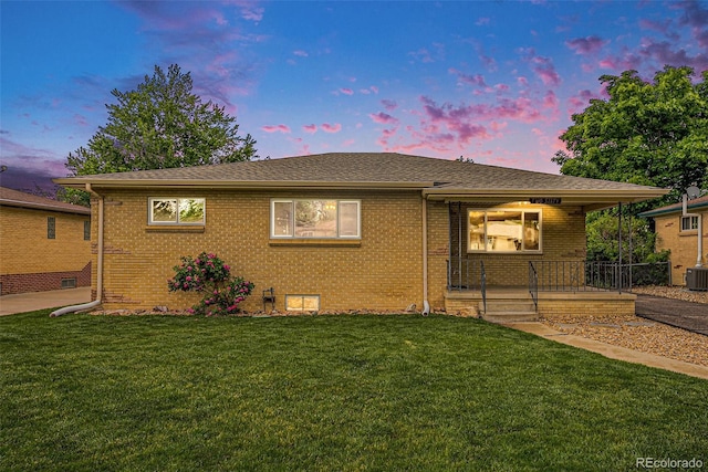 260 Flint Way, Broomfield, CO 80020 - view of front of house featuring brick siding, a yard, covered porch, and central air condition unit