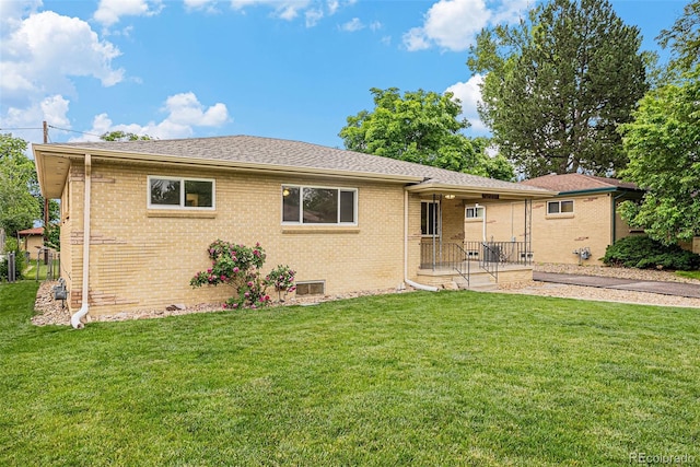 260 Flint Way, Broomfield, CO 80020 - rear view of house featuring brick siding, a lawn, and a shingled roof