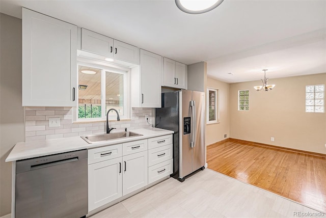 260 Flint Way, Broomfield, CO 80020 - kitchen featuring appliances with stainless steel finishes, a sink, light countertops, backsplash, and baseboards