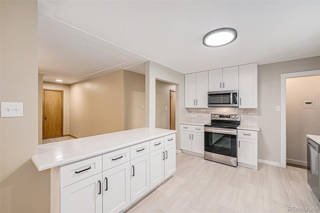 260 Flint Way, Broomfield, CO 80020 - kitchen featuring stainless steel appliances, light countertops, tasteful backsplash, and white cabinets