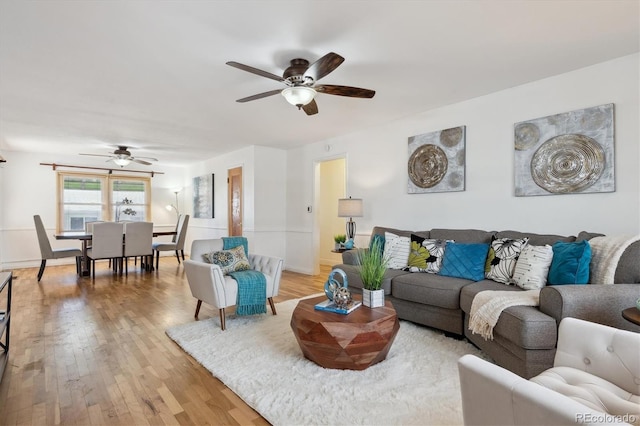 living room featuring ceiling fan and light wood-type flooring