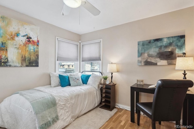 bedroom with hardwood / wood-style flooring and ceiling fan