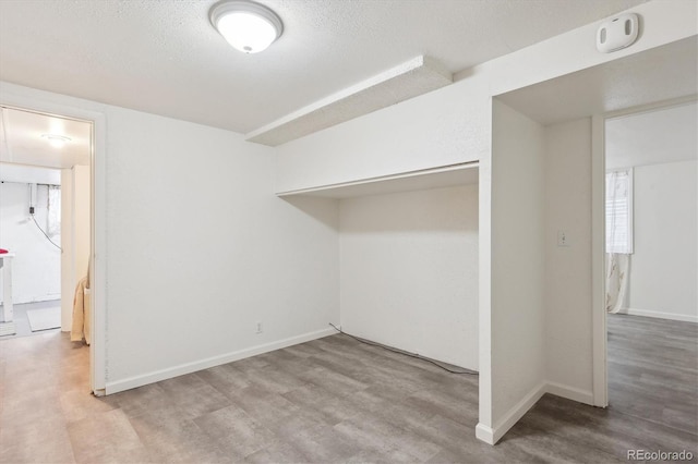 unfurnished room featuring a textured ceiling