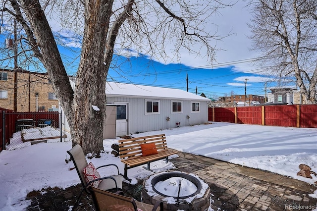 snow covered house with a fire pit