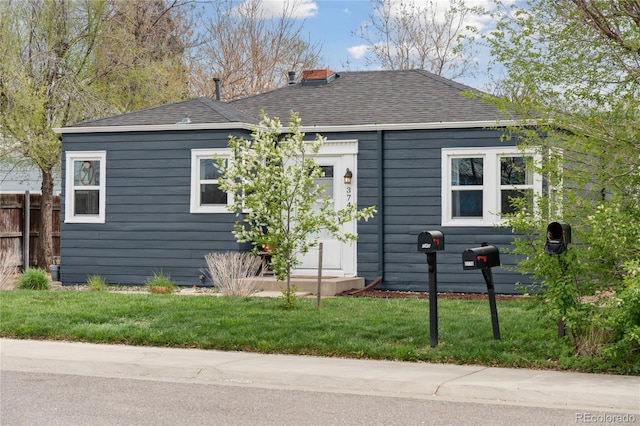 single story home featuring a shingled roof, fence, and a chimney