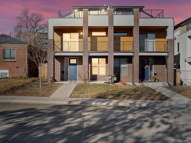 view of front of property with stucco siding and brick siding