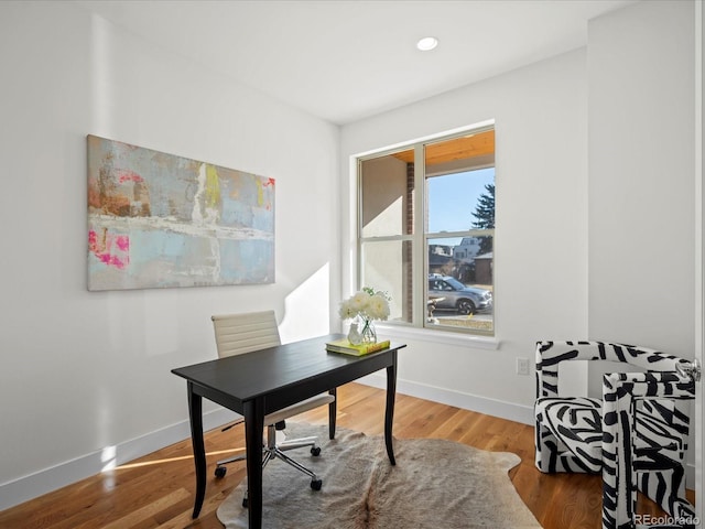 office space featuring baseboards, wood finished floors, and recessed lighting