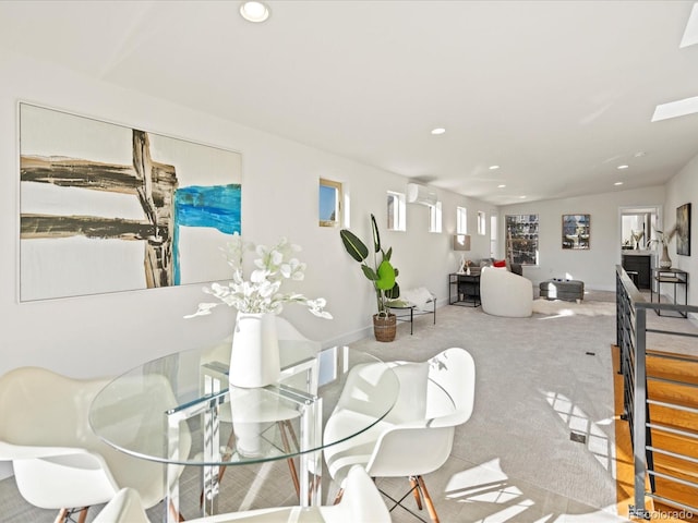 dining area featuring an AC wall unit, carpet, and recessed lighting