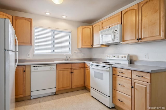 kitchen featuring light brown cabinets, white appliances, and sink