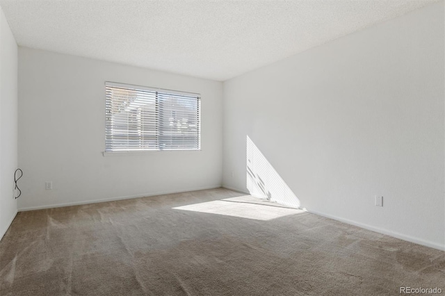 unfurnished room with a textured ceiling and carpet