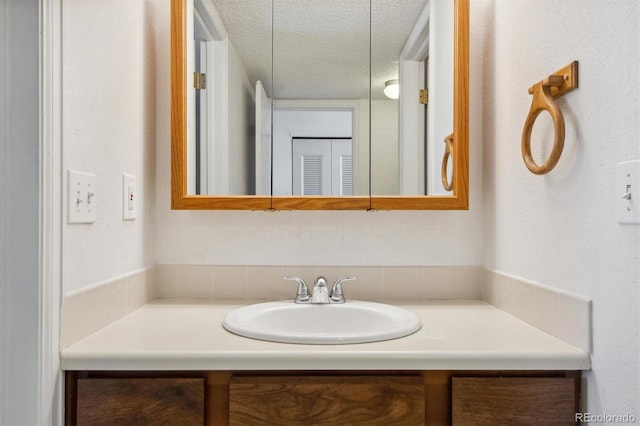 bathroom featuring vanity and a textured ceiling