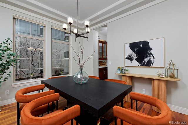 8044 E 24th Ave, Denver, CO 80238 - dining room featuring a chandelier, wood finished floors, and baseboards