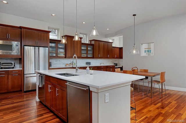 8044 E 24th Ave, Denver, CO 80238 - kitchen with appliances with stainless steel finishes, a sink, dark wood-style flooring, an island with sink, and recessed lighting