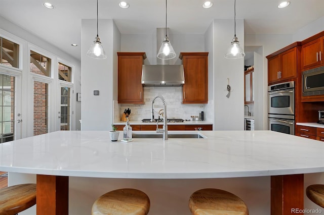 8044 E 24th Ave, Denver, CO 80238 - kitchen with appliances with stainless steel finishes, backsplash, recessed lighting, a breakfast bar, and pendant lighting
