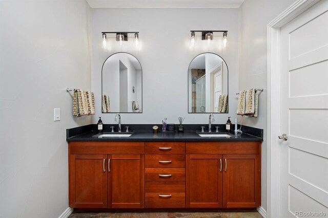 8044 E 24th Ave, Denver, CO 80238 - full bath featuring double vanity, a shower with door, and baseboards
