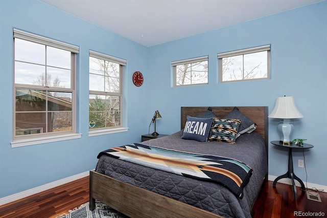 8044 E 24th Ave, Denver, CO 80238 - bedroom featuring wood finished floors, baseboards, and multiple windows