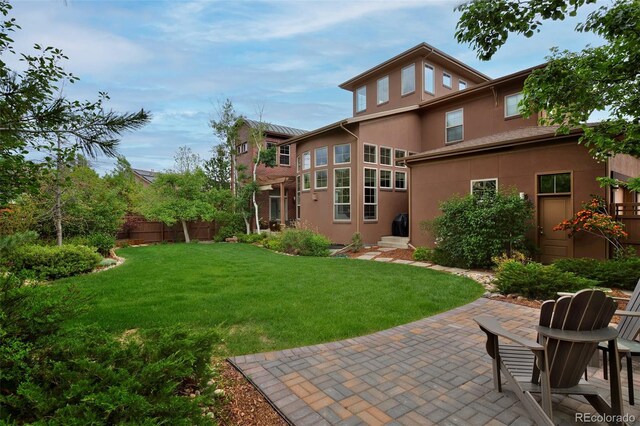 8044 E 24th Ave, Denver, CO 80238 - rear view of property with stucco siding and a patio