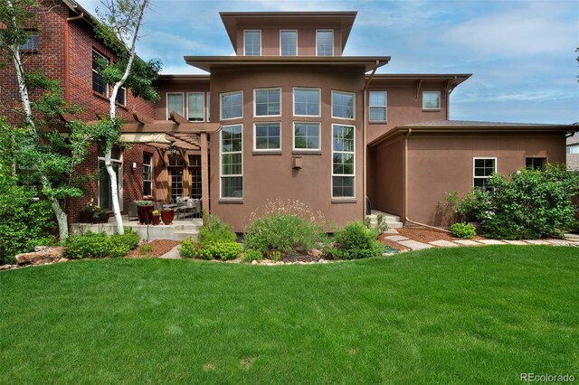 8044 E 24th Ave, Denver, CO 80238 - rear view of house featuring stucco siding, a lawn, and a patio