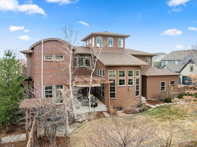 8044 E 24th Ave, Denver, CO 80238 - back of house with stucco siding, a shingled roof, and a patio area