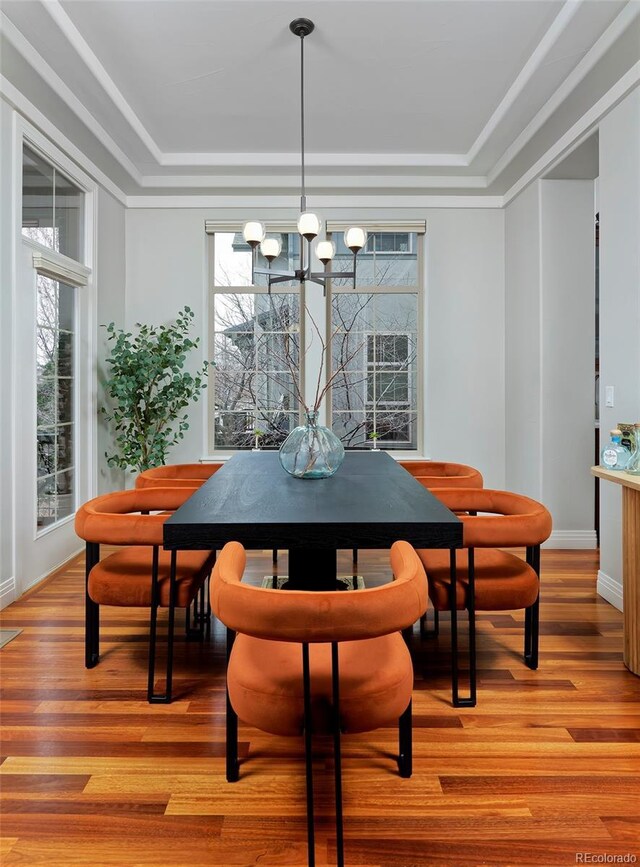 8044 E 24th Ave, Denver, CO 80238 - dining room with a tray ceiling, a chandelier, light wood-style flooring, and baseboards