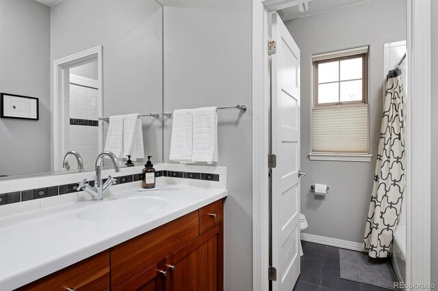 8044 E 24th Ave, Denver, CO 80238 - bathroom featuring vanity, toilet, tile patterned flooring, and baseboards
