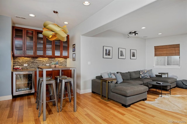 8044 E 24th Ave, Denver, CO 80238 - bar with wine cooler, tasteful backsplash, light wood finished floors, baseboards, and recessed lighting