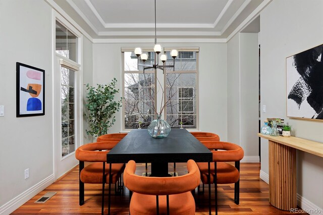 8044 E 24th Ave, Denver, CO 80238 - dining space with a chandelier, a tray ceiling, wood finished floors, and baseboards