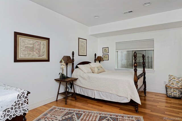 8044 E 24th Ave, Denver, CO 80238 - bedroom with wood finished floors, baseboards, and recessed lighting