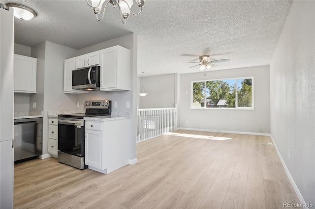 kitchen with ceiling fan with notable chandelier, light wood-type flooring, white cabinets, and appliances with stainless steel finishes