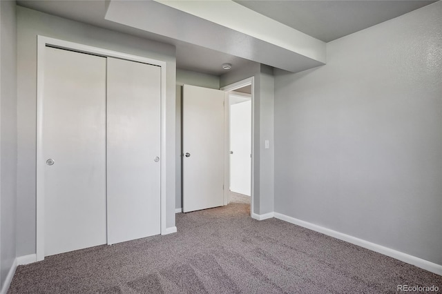 unfurnished bedroom featuring a closet and light colored carpet