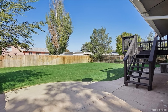 view of yard with a deck, a patio area, and central AC