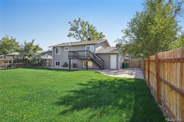 back of house featuring a wooden deck and a yard