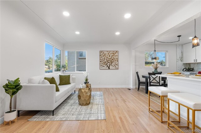 3541 Eudora St, Denver, CO 80207 - living room featuring recessed lighting, light wood finished floors, and baseboards