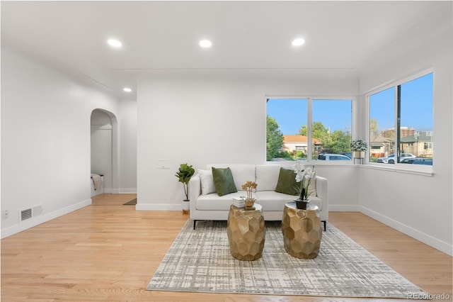 3541 Eudora St, Denver, CO 80207 - sitting room featuring arched walkways, recessed lighting, light wood-style flooring, and baseboards