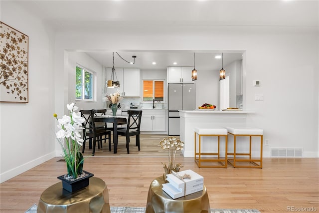 3541 Eudora St, Denver, CO 80207 - living room featuring light wood-style flooring, baseboards, and recessed lighting