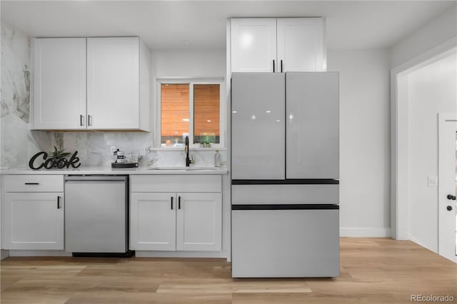 3541 Eudora St, Denver, CO 80207 - kitchen with a sink, appliances with stainless steel finishes, white cabinetry, and light countertops